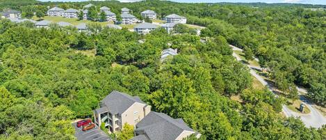 A residential area with multiple two-story houses, a parking lot, and a road.