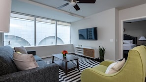 Relax in this stylish living room with a city view, flat-screen TV, and comfortable seating area.