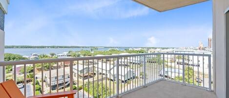 A balcony with a view of a marina and buildings.