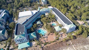 Vista aérea de un complejo hotelero con varias construcciones, piscina y zonas ajardinadas.