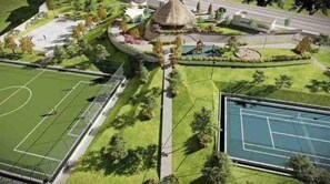 A sports complex with multiple tennis courts, a central pavilion, and surrounding landscaped areas.