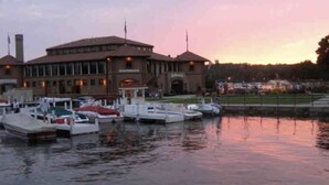 A marina with docked boats and a large building with a brick facade.