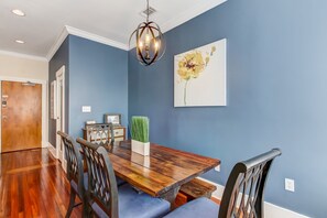 Enjoy meals in this dining area with a wooden table and comfortable chairs.