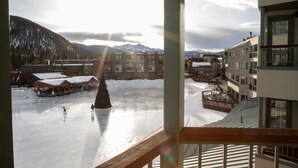 A view of a snow-covered outdoor area with buildings in the background and a wooden railing in the foreground. - On Keystone Lake/Shuttle to Lifts/Pool and Hot Tub Access/Great Amenities (dillon)