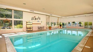 An indoor swimming pool with clear windows, a reception desk, and a seating area. - On Keystone Lake/Shuttle to Lifts/Pool and Hot Tub Access/Great Amenities (dillon)