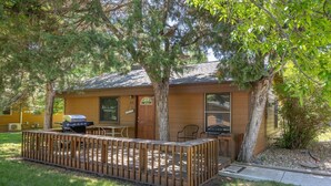 A small cabin with a deck, a grill, and a door marked "23". - Make Memories from your Deck - In Rapid City On Canyon Lake Thirty Minutes from Mt Rushmore (Rapid City)