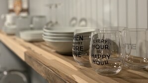 A kitchen counter with various glassware and plates. - Happy Hour ACROSS THE STREET FROM THE BEACH (Treasure Island)