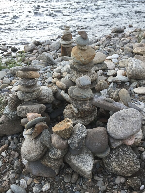 A collection of stacked stones on a rocky shore.