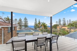 Enjoy dining or socializing on the spacious balcony with a table and chairs.
