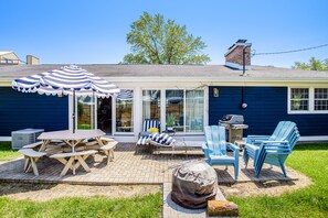 Enjoy al fresco dining and outdoor cooking in the patio area, complete with a grill and comfortable seating.
