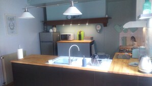 A compact kitchen with a sink, a microwave, and a refrigerator.