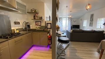 Comfort Apartment, 1 Queen Bed | Living area | 120-cm TV with digital channels