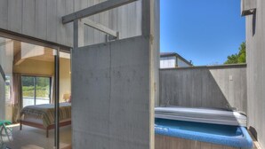 A room with a bed, a window, and a sauna area. - Silver Mist | Pool with Stargazing Decks (The Sea Ranch)