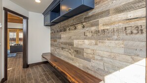 A modern kitchen with a wooden plank backsplash and a built-in bench. - Ski In/Out home 50 steps to Bear Back Poma Lift w/steam shower - Big Horn Escape (Big Sky)