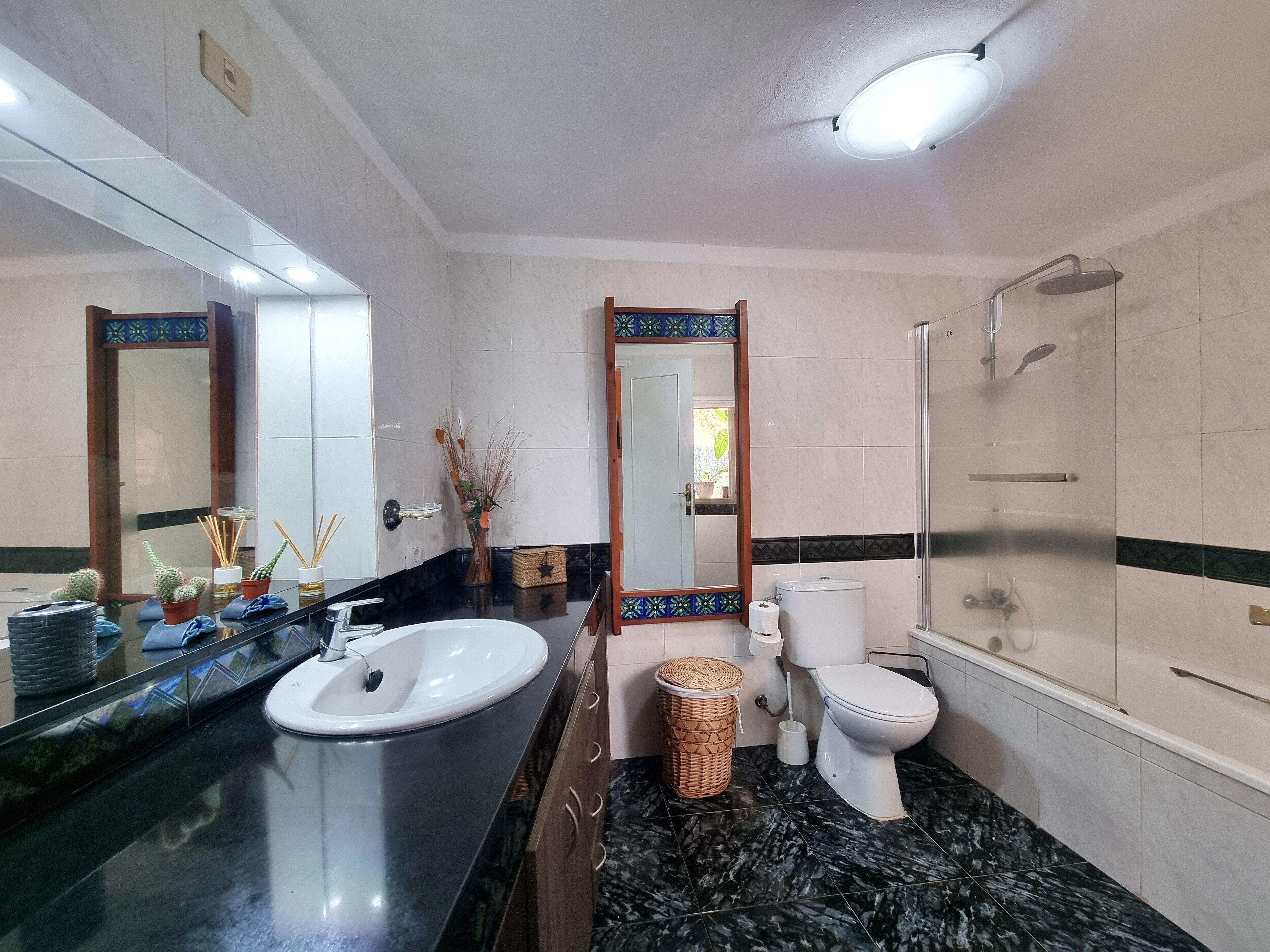 A bathroom with a sink, toilet, and shower.