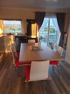 The main kitchen ‘ living’ area with patio doors leading to the rear balcony