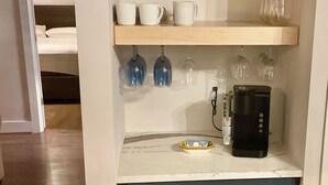 A kitchenette with a coffee maker, shelves with glassware, and a microwave. - Breathtaking lake views, steps from beach, golf, and clubhouse. Renovated home! (Big Canoe)