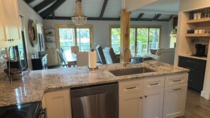 A modern kitchen with granite countertops, stainless steel appliances, and a central island. - Breathtaking lake views, steps from beach, golf, and clubhouse. Renovated home! (Big Canoe)