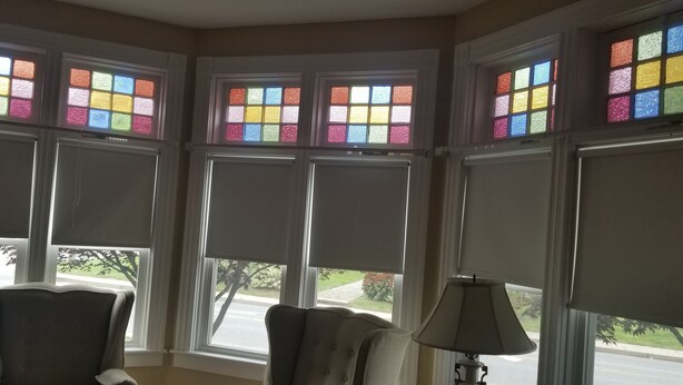 A room with large windows featuring colorful stained glass, a lamp, and two chairs. - Spacious Updated Victorian, A/C, Walk to Beach, Close to Town  (Narragansett)
