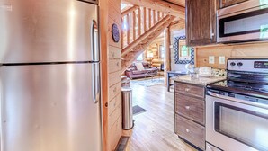 A kitchen with wooden cabinets, stainless steel appliances, and a stone countertop. - Fontana View 1 - Ridgetop - Gated Community (Almond)
