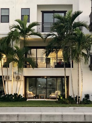 Enjoy a home away from home with a balcony overlooking lush surroundings and a seating area below.