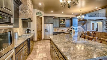 A spacious kitchen with granite countertops, stainless steel appliances, and a large island.