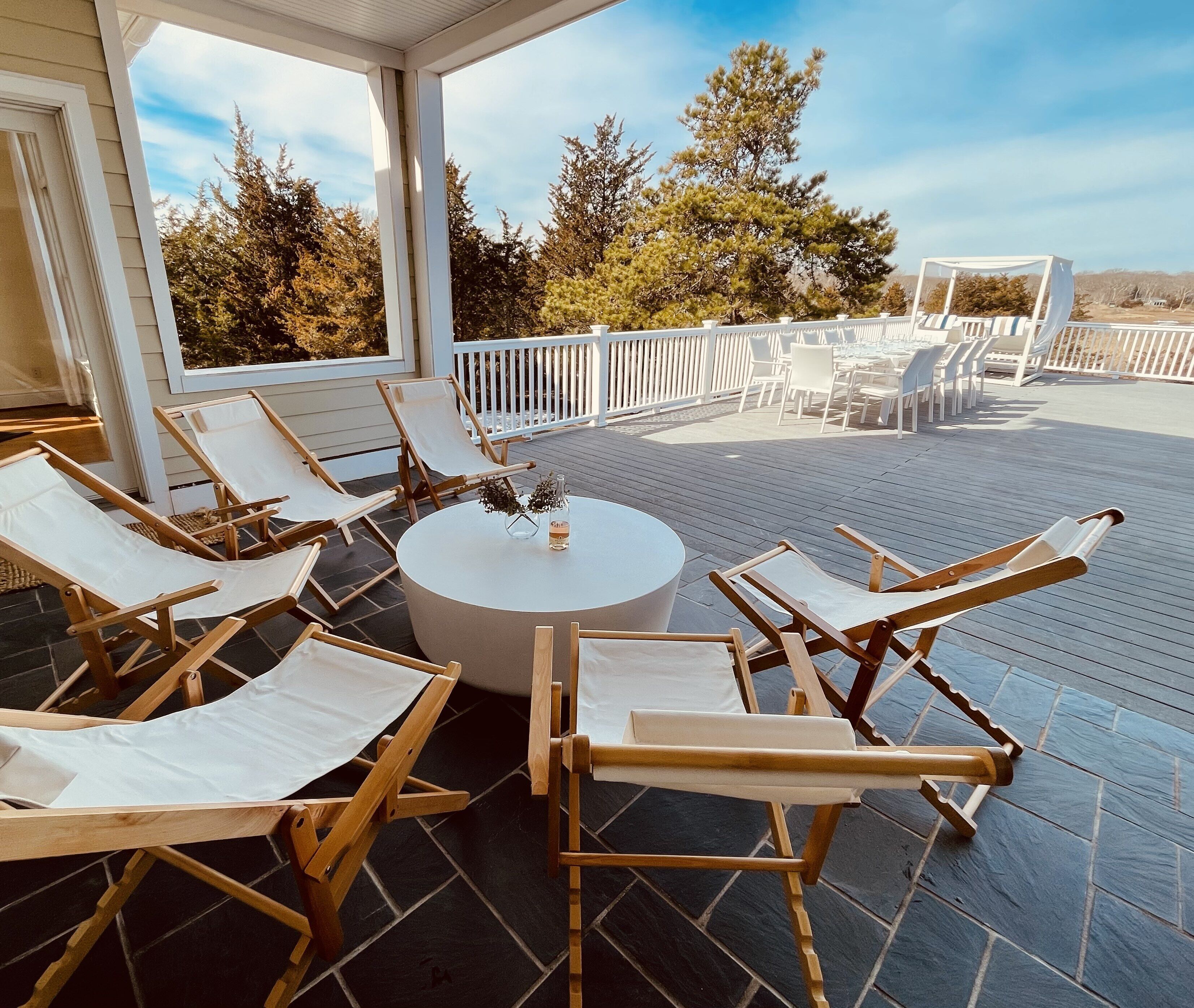 lounge under a covered porch with high powered fan overlooking the property 