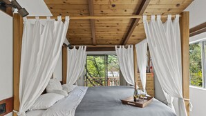 A bedroom with a large bed, white curtains, and a wooden ceiling. - Spacious Serene Sanctuary-Minutes to SF and Muir Woods (Mill Valley)