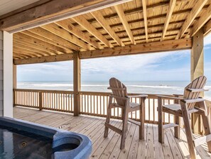 A wooden deck with a view of the ocean, two Adirondack chairs, and a hot tub. - Sunrises, Sunsets☀️Hot Tub, Shared Pool, Beach Chairs, Oceanfront, SUMMER SALE (Avon)