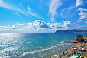 A beach with a clear sky, a rocky outcrop, and a tower. - Paradiso Al Mare Terrace and Shared pool, Diano Marina, Italy (Diano Marina)