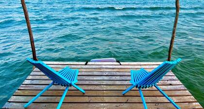 Beachfront surrounded by lush natural jungle. Snorkle from shore manatee watch