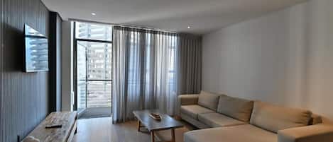 Two Bedroom Apartment | Living area | 32-inch flat-screen TV with satellite channels, TV