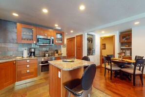 Enjoy cooking in this well-equipped kitchen with a central island, microwave, and coffee maker.