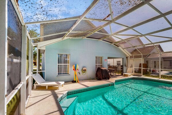 Relax by the pool surrounded by a transparent roof and lounge chairs.