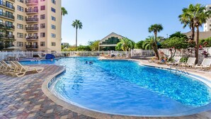 A swimming pool with lounge chairs and palm trees. - Stylish Condo CDC Standards Private Balcony 2BD 2BA 6en165 (Orlando)
