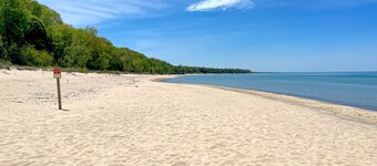Fully-renovated lakefront home with beach cabana, association beach, & firepit
