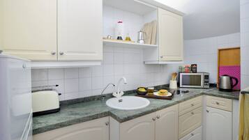 Fridge, microwave, stovetop, coffee/tea maker