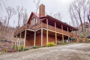 A log cabin with a balcony, a chimney, and a porch. - Christmas Bear Cabin is one of  a few Authentic Log Cabins on Wiley Oakley/Ski Mountain. (Gatlinburg)
