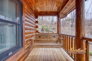 Sit on the porch and enjoy the serene surroundings from the comfort of this cozy cabin.