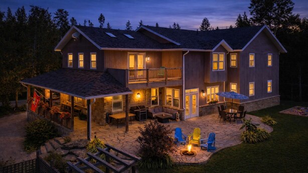 A two-story house with a covered patio area, outdoor seating, and a fire pit. - Bruce “GOLF” Getaways (Lion's Head)