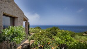 Enjoy a serene ocean view from this tranquil garden setting.