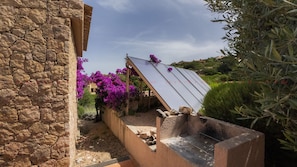 Experience the serene charm of this traditional home, surrounded by lush gardens and a rooftop equipped with solar panels.