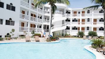 Enjoy a refreshing swim in the central courtyard pool, surrounded by balconies offering a view of the pool area.