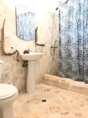 Ein Badezimmer mit Waschbecken, Toilette und Dusche.