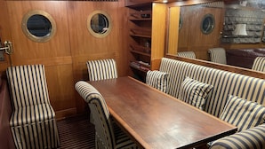 A dining area with striped upholstered chairs and a wooden table.