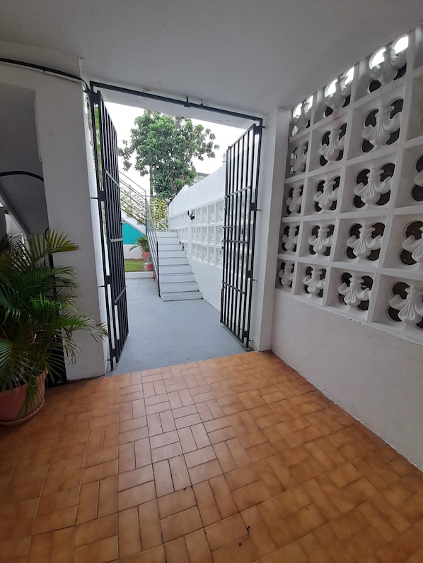 Staircase corridor with a potted plant and decorative panel.