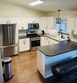 Microwave, dishwasher, coffee/tea maker, cookware/dishes/utensils