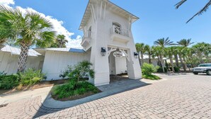 A white building with a balcony and a sign that reads "The Gathering Place". - 🐙Golf Cart + Bikes Included-Pools-2 Masters-Octopus's Garden🐙 (Santa Rosa Beach)