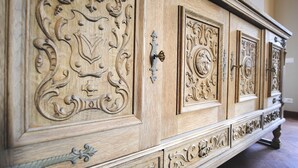 A large, ornate wooden cabinet with intricate carvings and a brass handle. - Chianti Tuscany: a villa with a view (Lucolena)