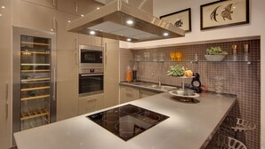 Una cucina moderna con elettrodomestici integrati, una grande isola e piastrelle decorative.
